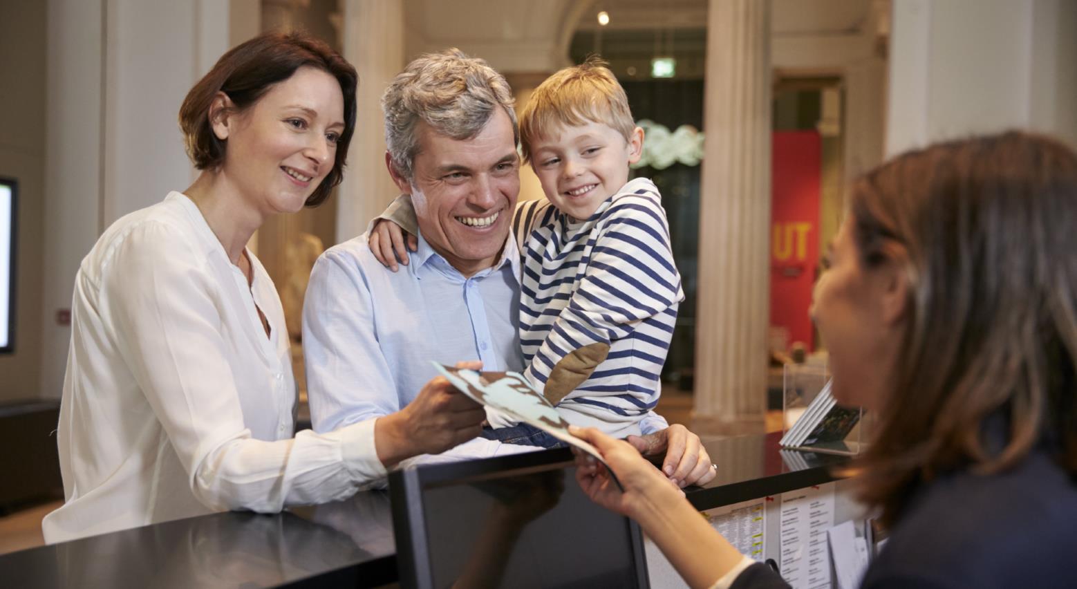 family at reception desk