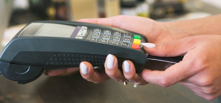 close up of woman's hand while she uses pin pad