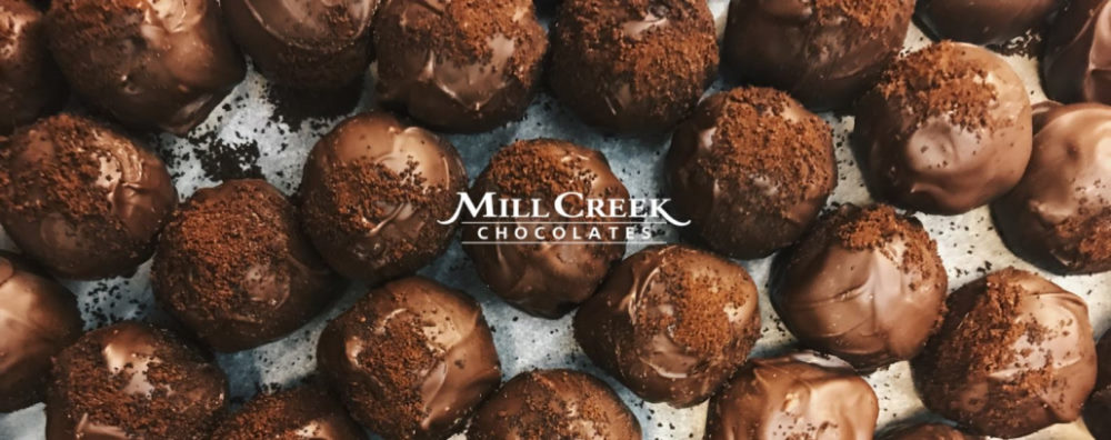 Chocolates and Mill Creek Chocolates logo