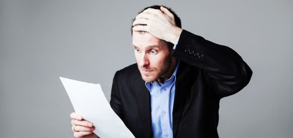 Surprised businessman reads statement